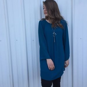 Above the knee dress, black leggings, necklace